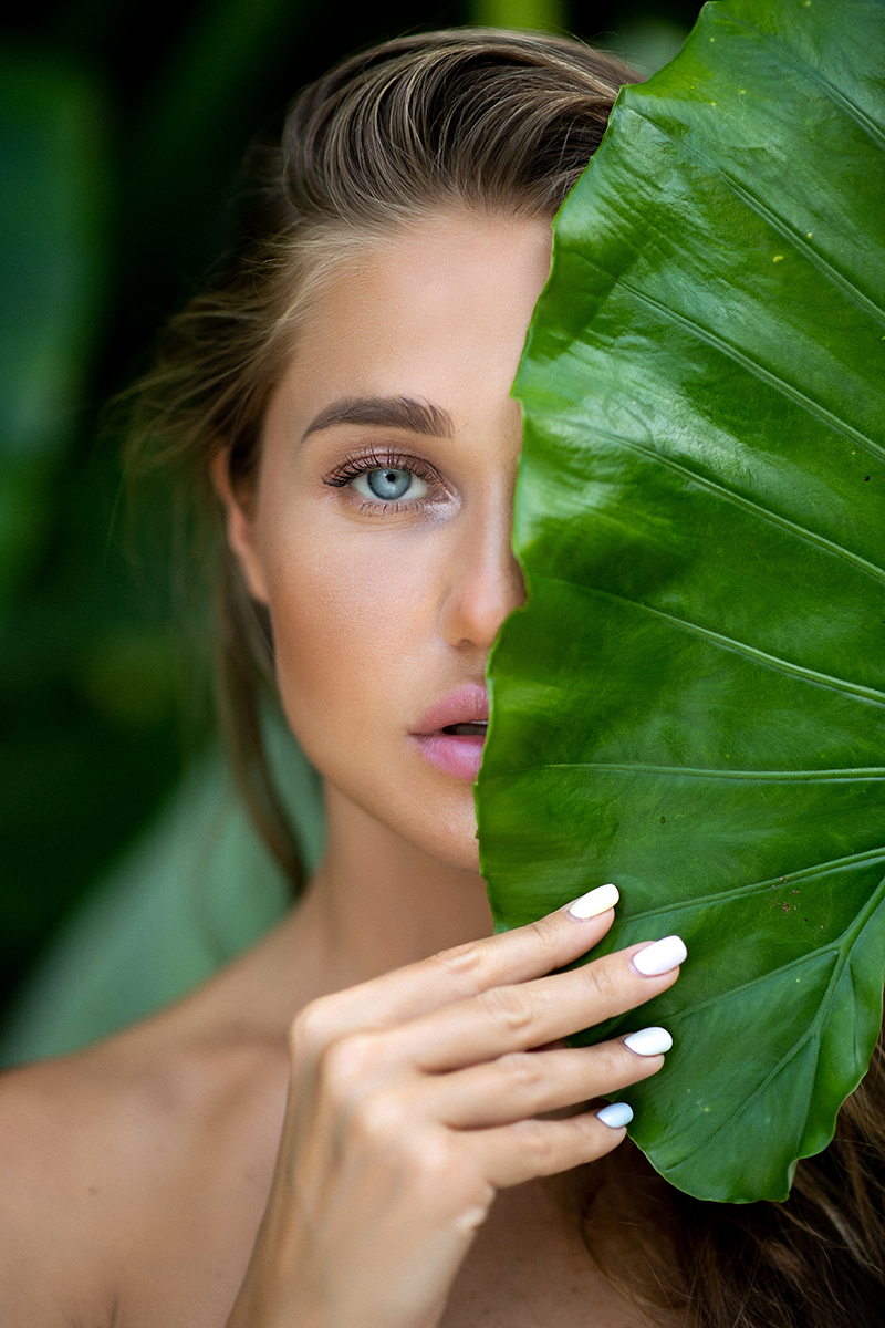 Woman gently touching her cheek during a calm skin assessment moment