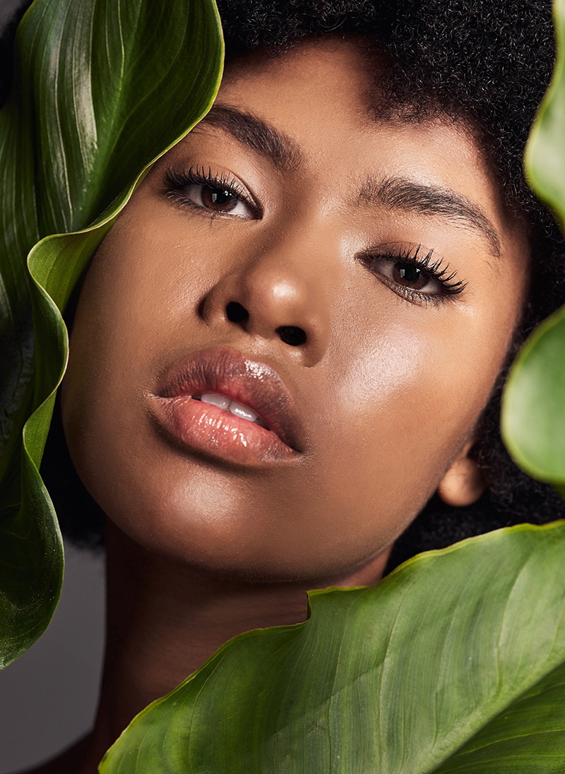 Woman gently applying natural face cream during her morning skincare ritual